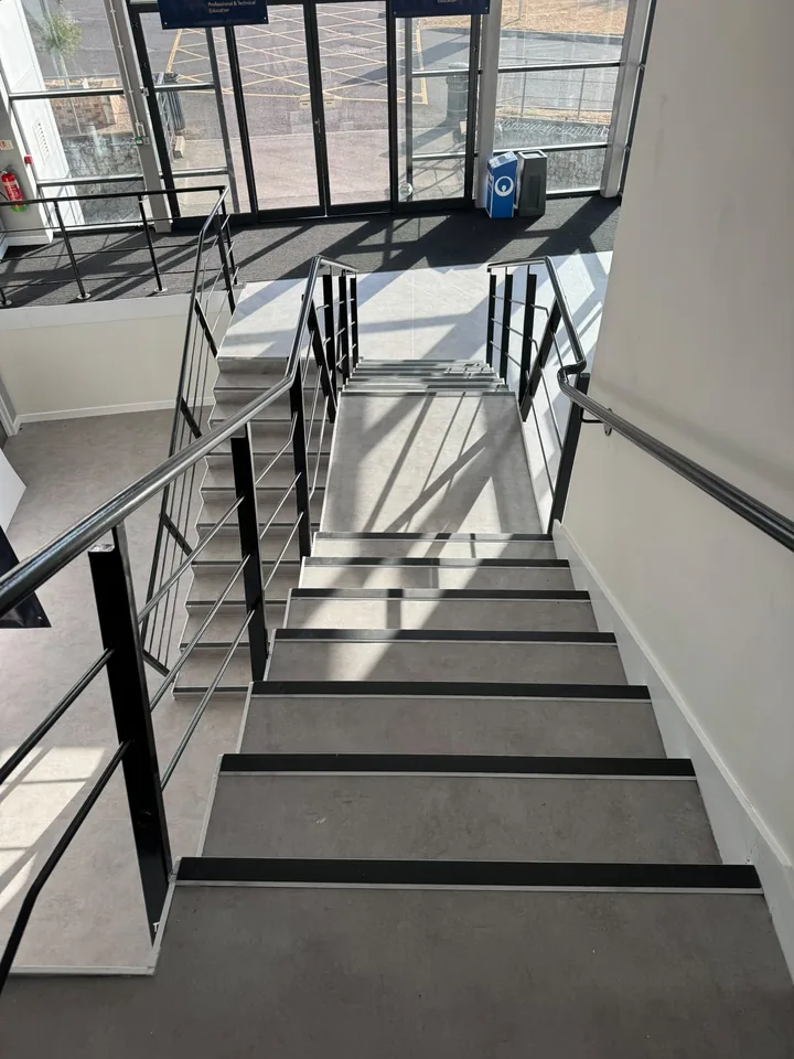 Flooring fitted to stairs and landings beside a glazed entrance